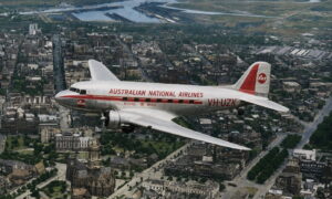 Vintage silver airliner with red stripe reading 'AUSTRALIAN NATIONAL AIRLINES' over a city, registration VH-UZK, early jet era styling with a cathedral visible below.